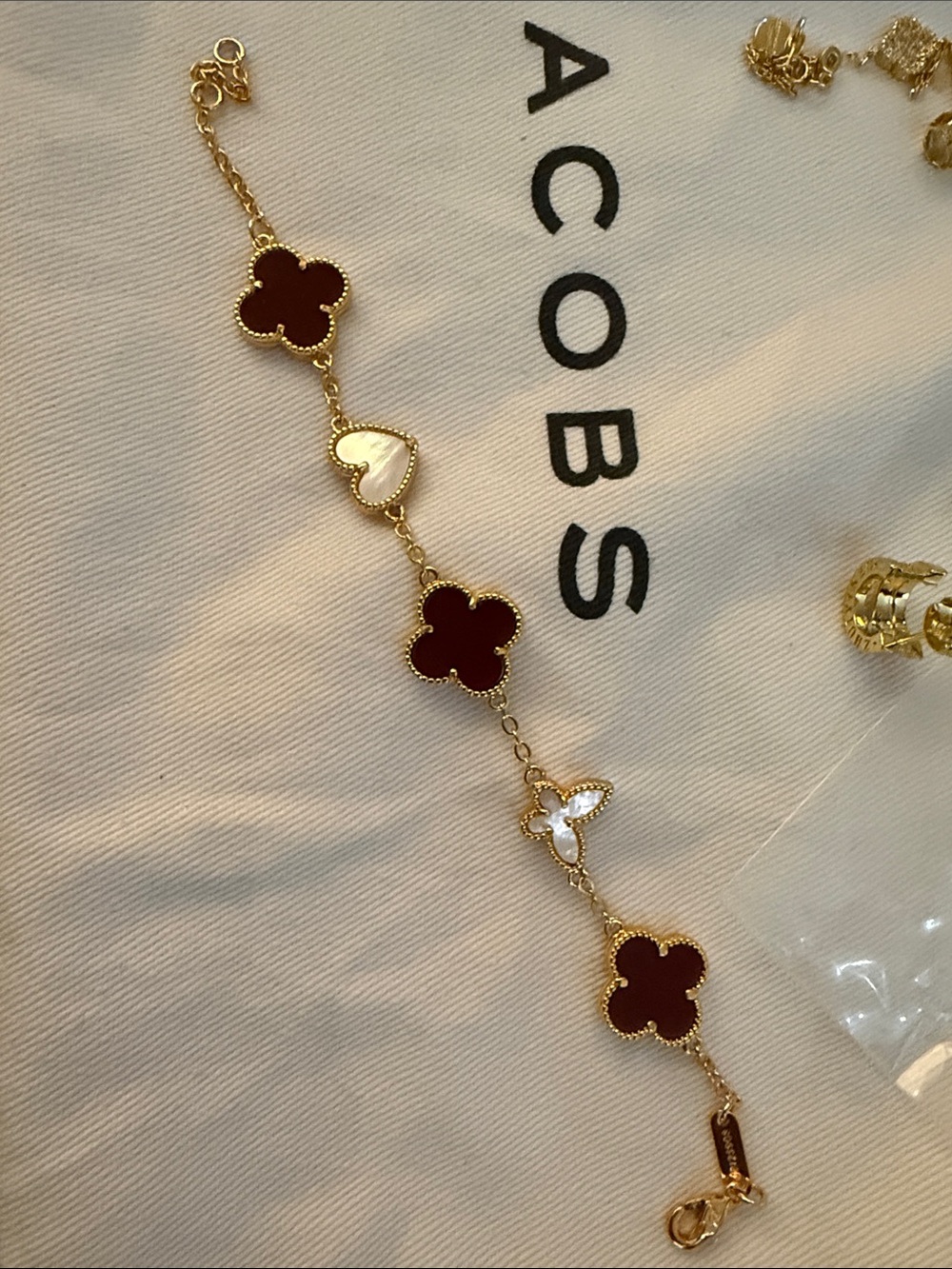 Gold-Tone Bracelet with Burgundy and Cream Clover Accents, hopd plated